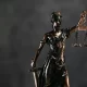 A bronze Lady Justice figure holding scales