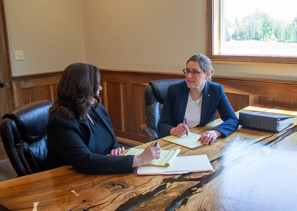 A Cornerstone attorney speaking with a Cornerstone paralegal