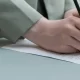 Someone's hand signing a document