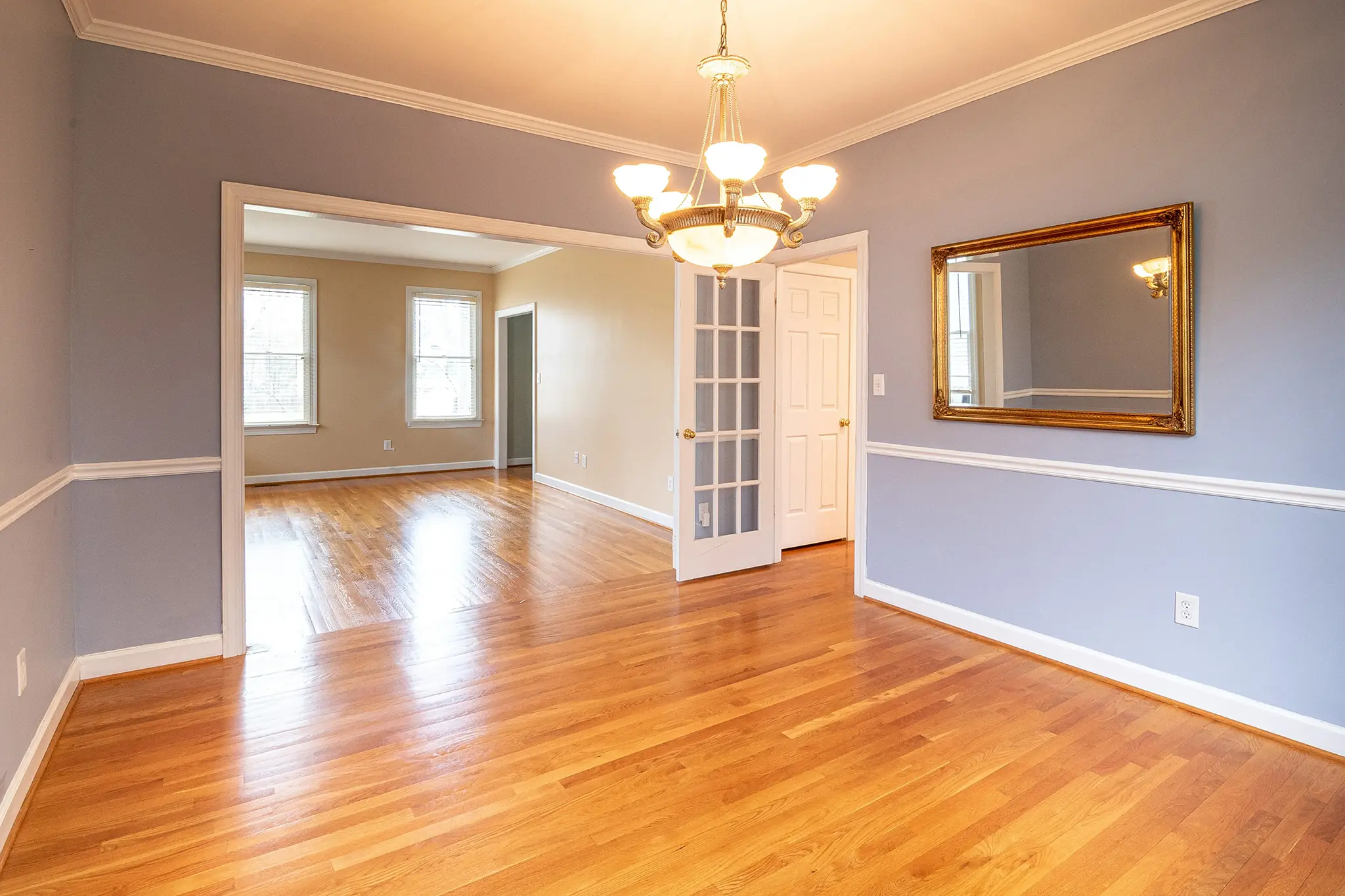 An empty, light blue dining room in a house for sale