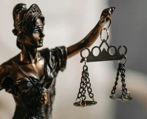 A Lady Justice statue holding some scales