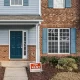 A house with a "for rent" sign in front of it