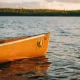 A boat on a lake at sunset