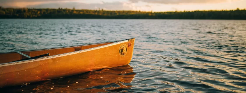 A boat on a lake at sunset