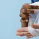 A doctor's hands wrapping an injured patient's hand with gauze