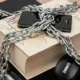 A laptop, book, and phone chained together to symbolize intellectual property protection