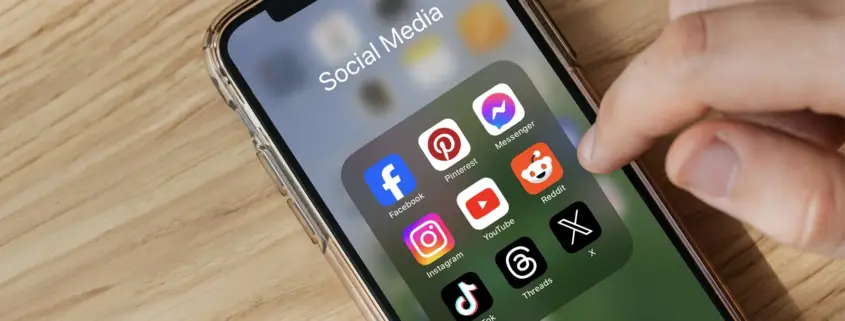 Phone with social media icons showing on the screen