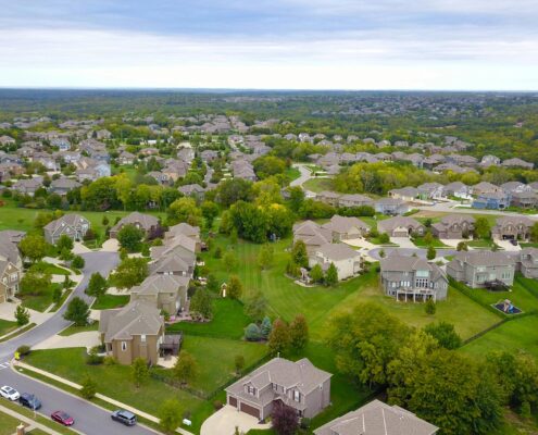 An aerial shot of a housing development to represent real property