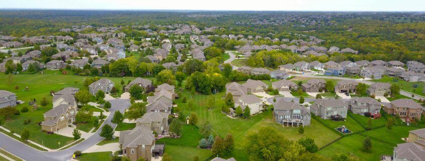 An aerial shot of a housing development to represent real property