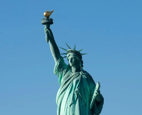 The Statue of Liberty against a clear blue sky