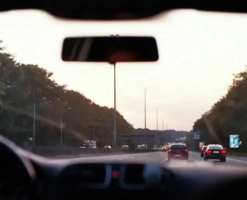 Cars on a highway as seen through a car's windshield