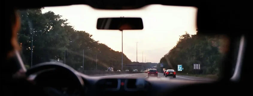 Cars on a highway as seen through a car's windshield