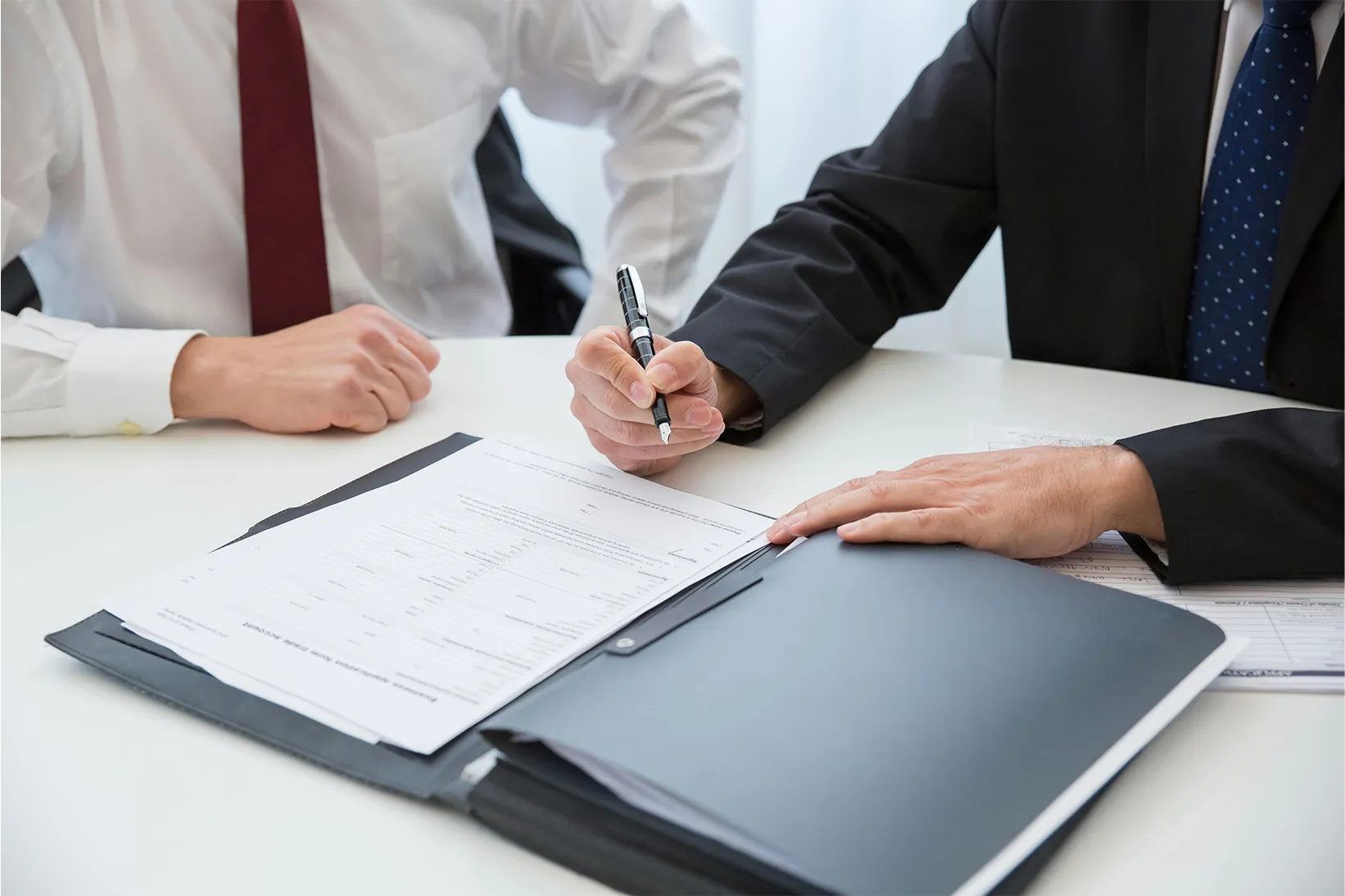 Two people reviewing paperwork