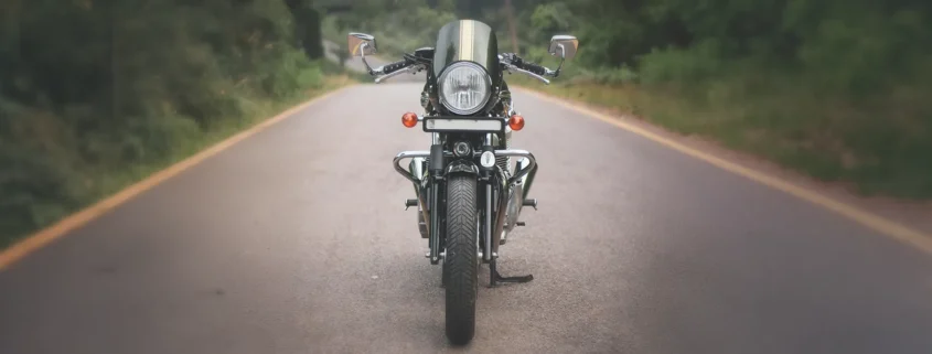 A motorcycle on a road in the woods