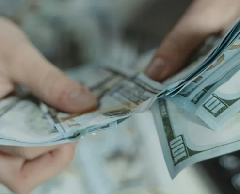 Someone counting a cash security deposit with a calculator nearby