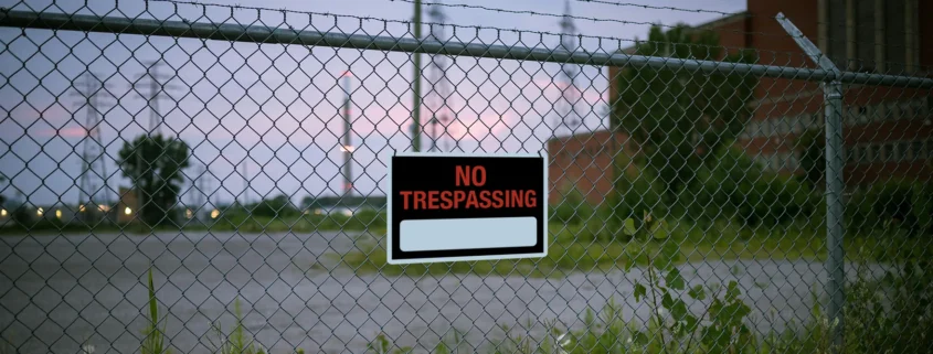 A fence with a No Trespassing sign