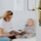 A parent visiting with their child and framed by a fancy doorway